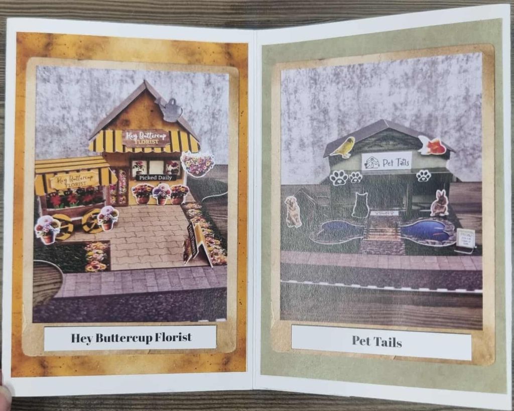 Miniature scenes of Hey Buttercup Florist and Pet Tails shop, with flower carts and animal-themed decorations. Showcasing other buildings from 3Quarter Lane series. 